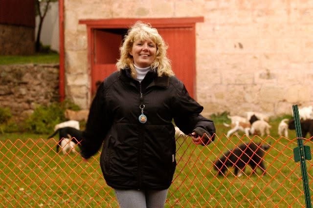 Portrait of Bonnie Judd smiling outdoors near a red barn
